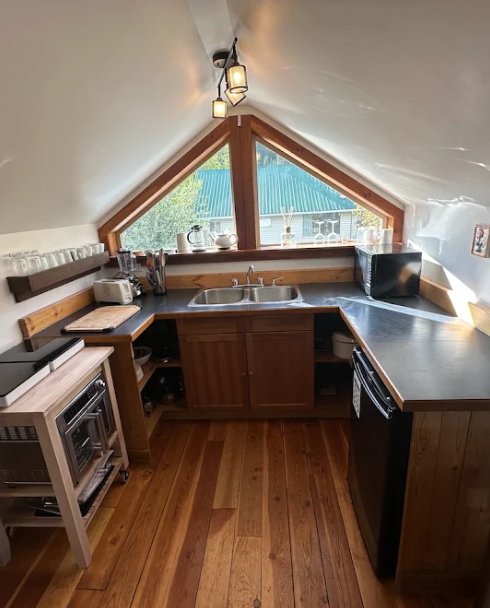 Attic suite kitchen with a vaulted ceiling and triangle window after interior painting