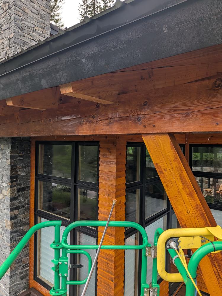 Close-up of freshly stained timber beam and siding seen from the lift basket